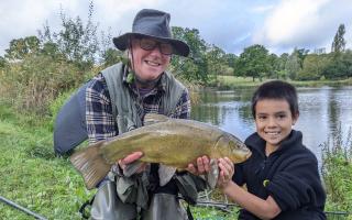 Robert Gibbs with a boy learning to fish on Hampstead Heath